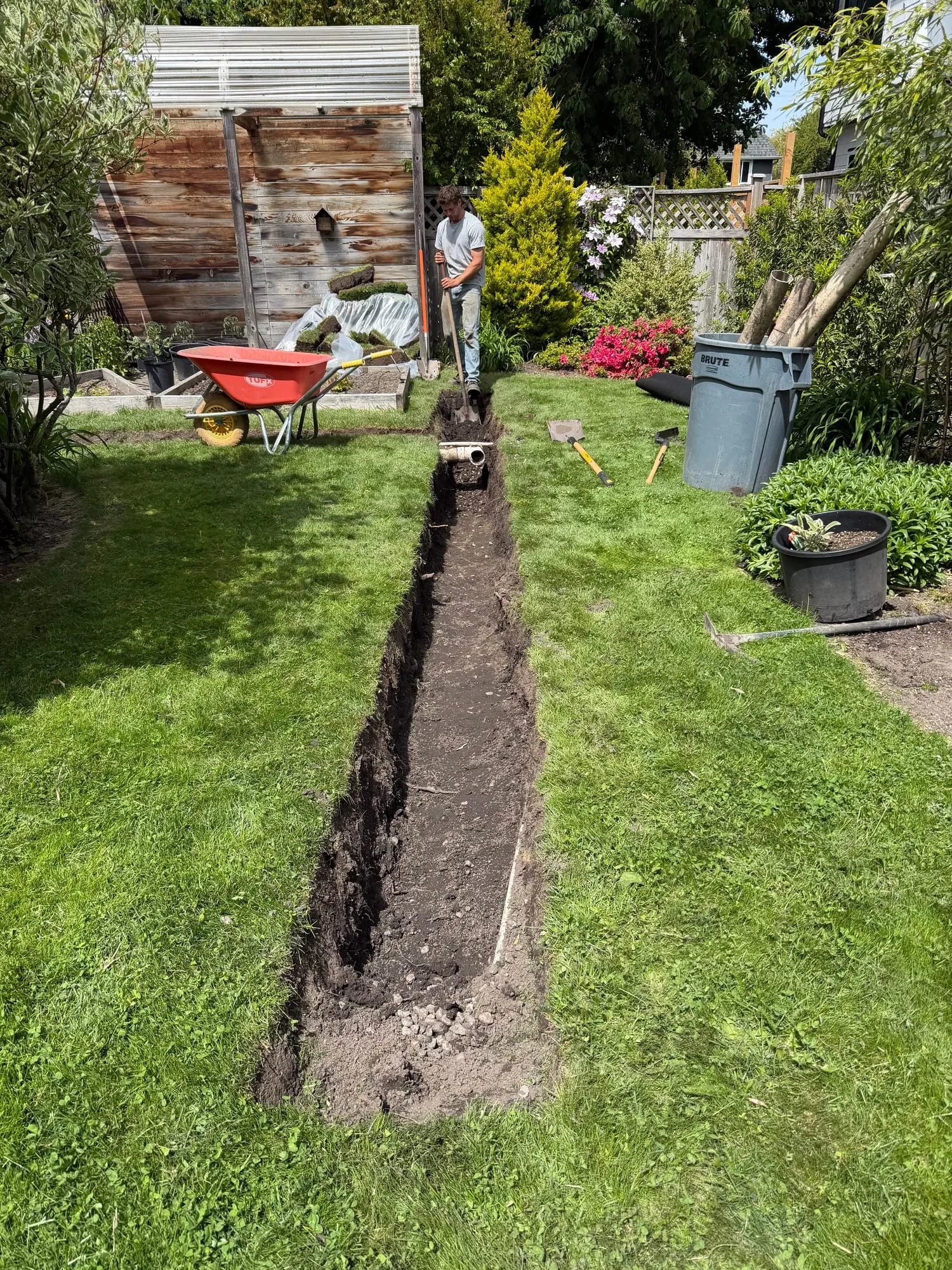 A T-shaped trench, dug to capture water across the whole yard.