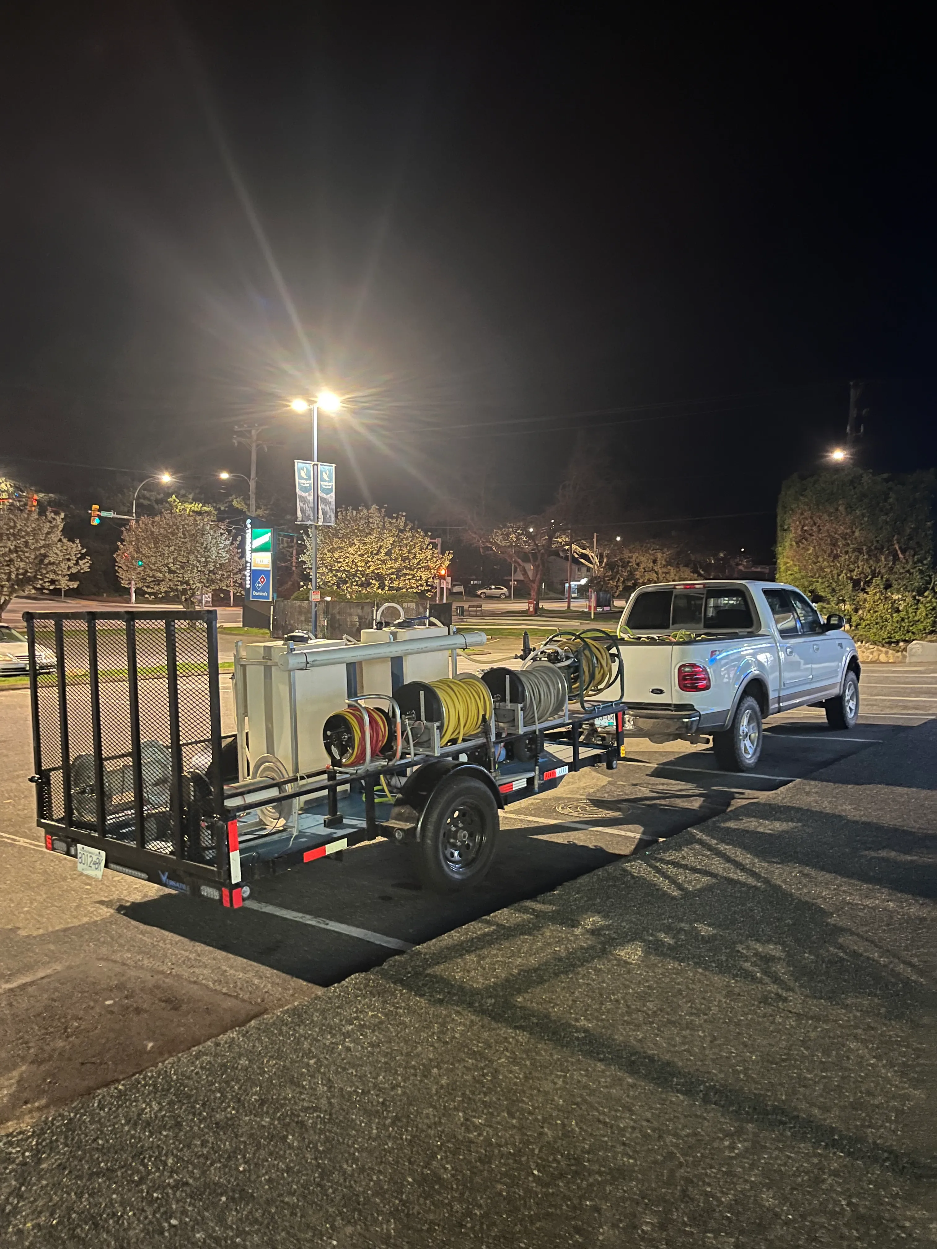 An F-150 towing a larger pressure-washing rig