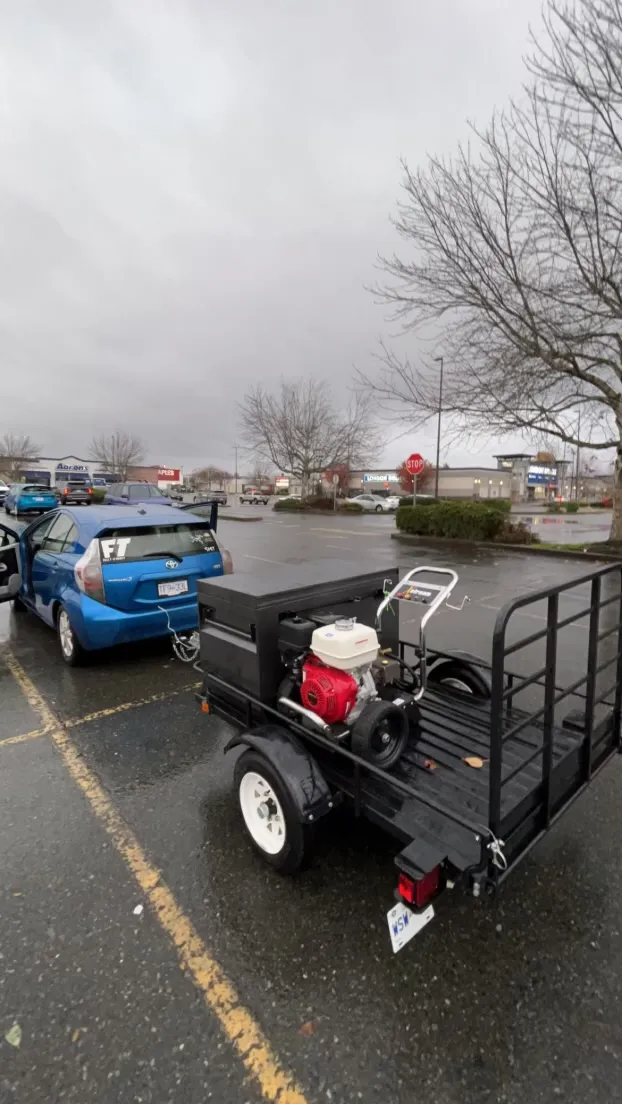 Drew’s Prius towing a small pressure-washing trailer